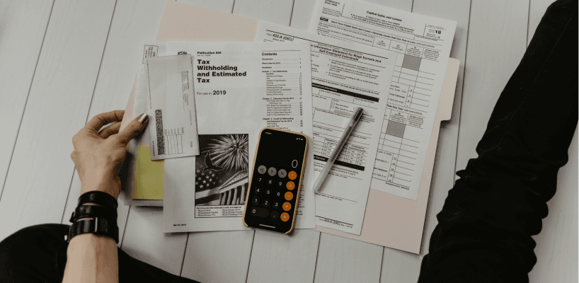 Planning documents and a calculator laid out for a project quote